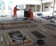 O Departamento Penitenciário do Paraná (Depen) assinou dois convênios com empresas privadas para empregar 36 detentos da Penitenciária Central do Estado – Unidade de Progressão (PCE-UP), localizada em Piraquara, na Região Metropolitana de Curitiba (RMC). Há cerca de um mês, tapetes higiênicos para cães e capachos estão sendo fabricados com mão de obra carcerária. A unidade também recebeu diversas melhorias estruturais, como pavimentação e novos espaços construídos pelos detentos.